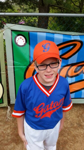 Ethan as a child playing baseball